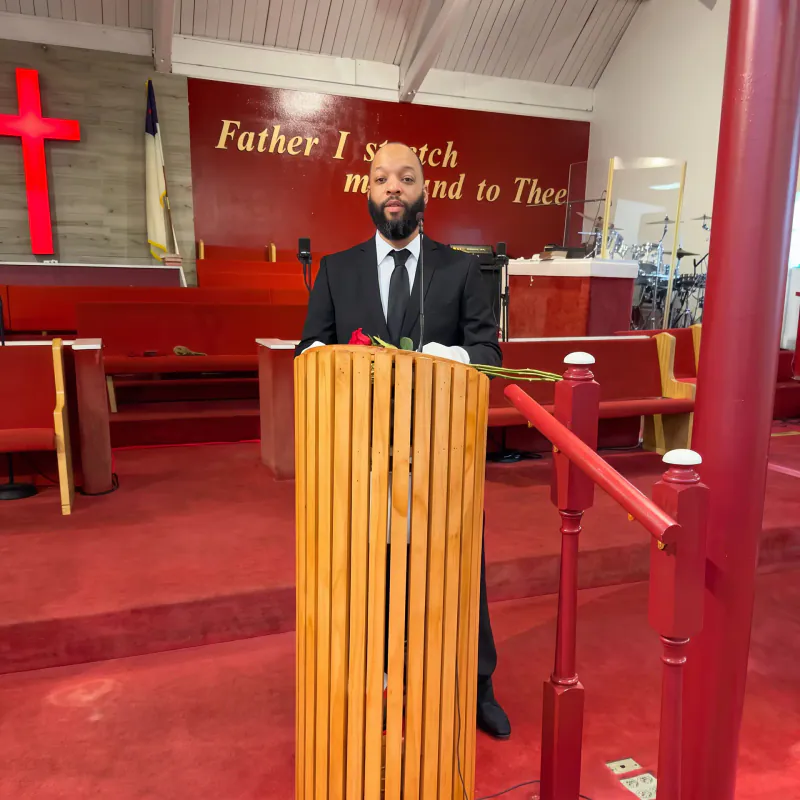 Anthony Cook speaking from the pulpit at a Maywood church